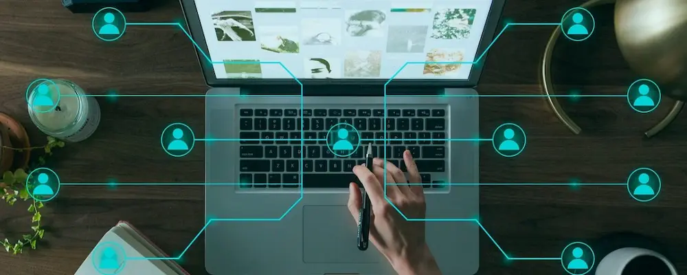 Hand on laptop with digital marketing graphics by a digital marketing analyst in calicut